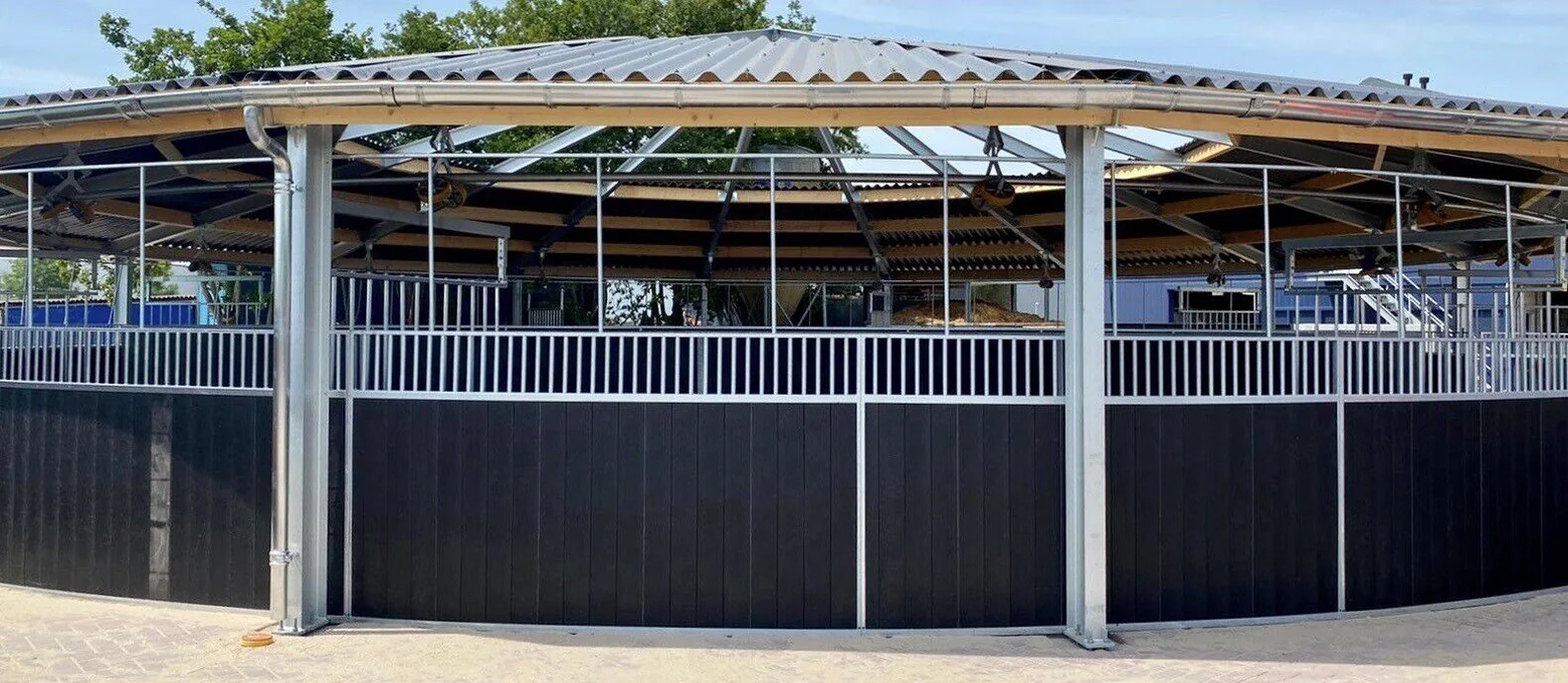 Covered horse walker with a corrugated-sheet roof on galvanised steel posts and a dark Round Fence